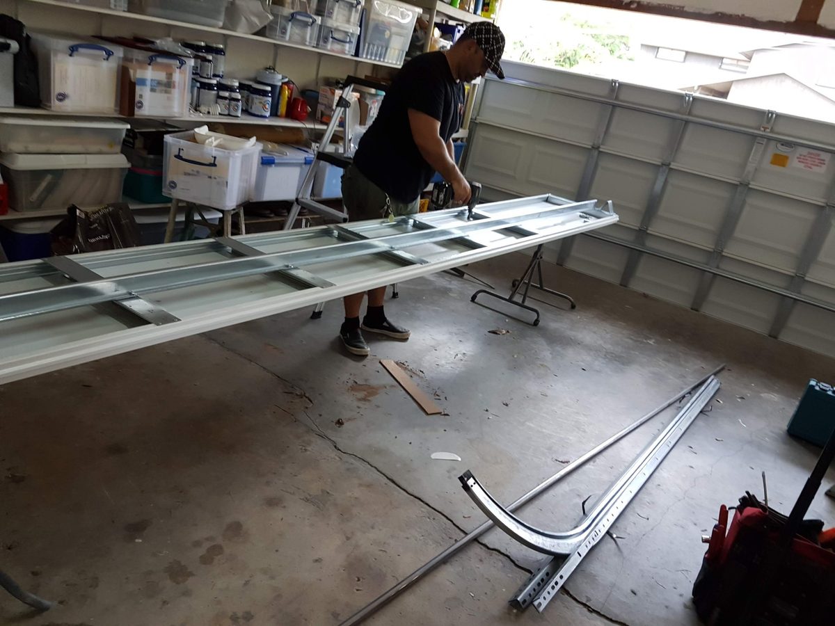 Garage door panel replacement in progress by OM Garage Door Florida technician