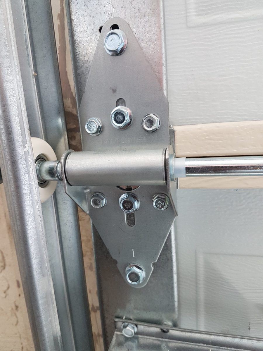 Garage door roller bracket detail — professional hardware installation