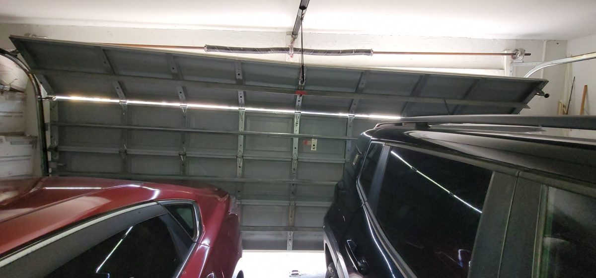 Garage door off track — interior view of crooked stuck door