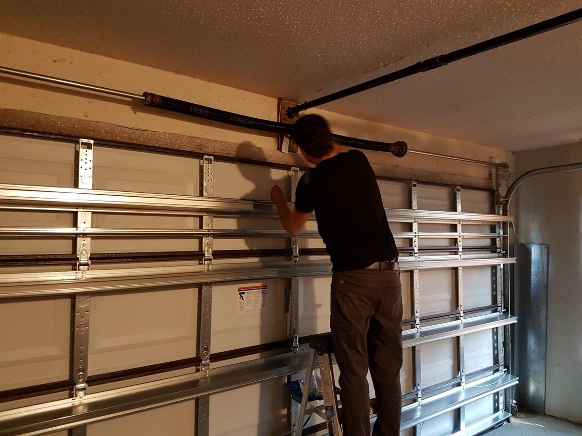 Oren Malul installing torsion springs on a garage door in Broward County
