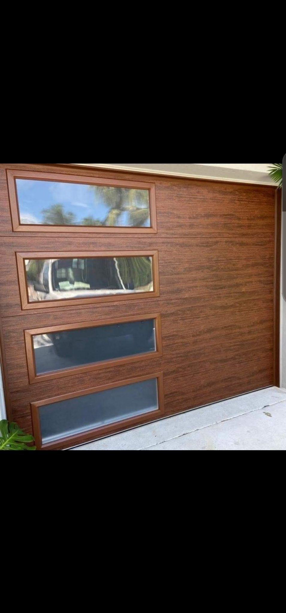 Wood-look garage door with windows installed in South Florida